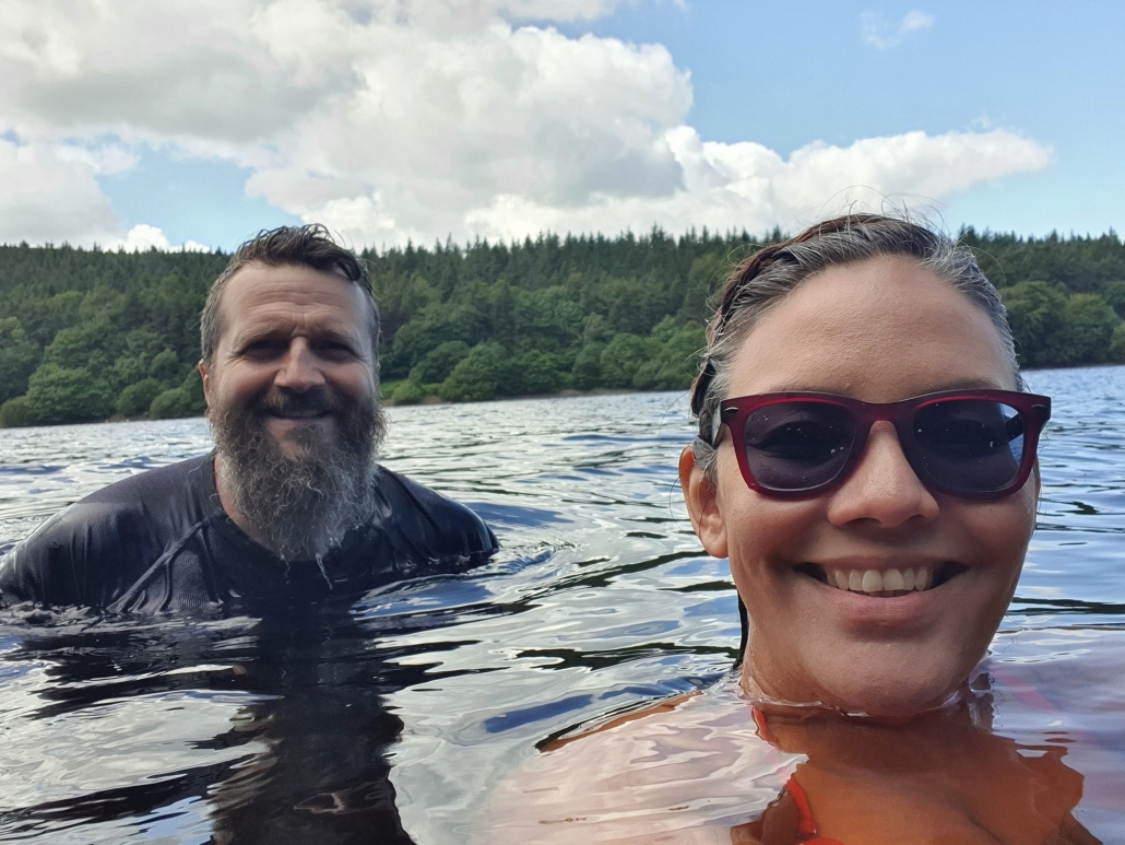 man and woman wild swimming