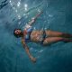 sam cleasby ostomy blogger health sheffield IBD blog woman in swimming pool in a bikini with an ileostomy colostomy